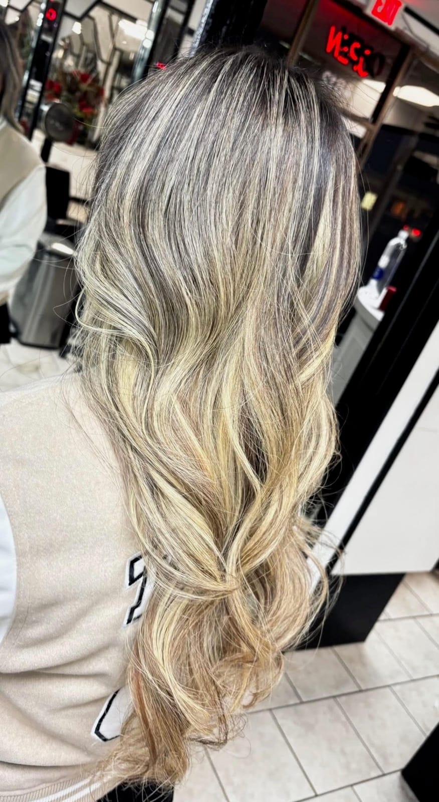 Blonde balayage with soft waves by Styled By Dani